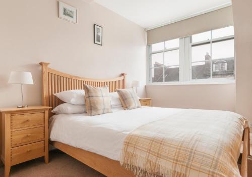 a bedroom with a large bed and a window at High Street Apartment in Edinburgh