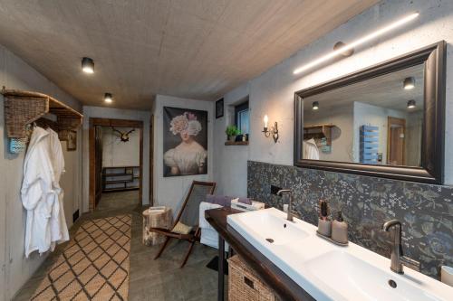 a bathroom with a sink and a mirror at Chalet Alte Schmiede in Göstling an der Ybbs
