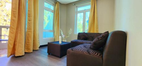 a living room with a couch and a candle on a table at Phoenix Beach Apartments sea view in Flic-en-Flac