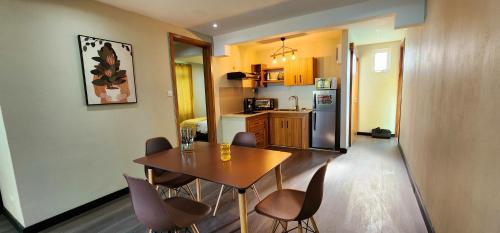 a kitchen with a table and chairs in a room at Phoenix Beach Apartments sea view in Flic-en-Flac