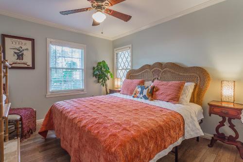 a bedroom with a large bed and a ceiling fan at Creekside Paradise in Tybee Island