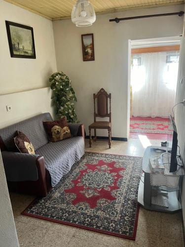 a living room with a couch and a table at Casa da Avó Maria, Largo de Santo António, n 97395AL in Freixo de Espada à Cinta