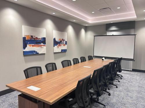 a conference room with a large wooden table and chairs at Hampton Inn By Hilton Kingston in Kingston