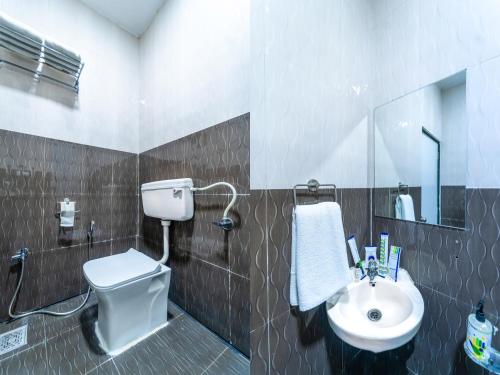 a bathroom with a toilet and a sink at Treebo Kaizen, 3 Kms From Paragliding in Panchgani
