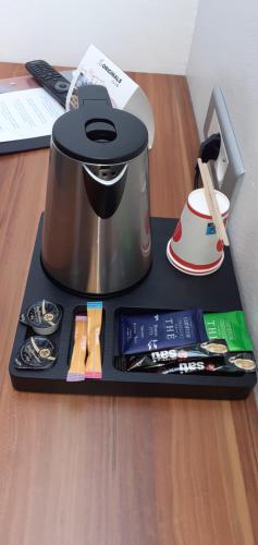 a black tray with a slow cooker on a table at The Originals City, Hôtel Colmar Gare in Colmar