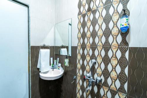 a bathroom with a sink and a mirror at Treebo Kaizen, 3 Kms From Paragliding in Panchgani