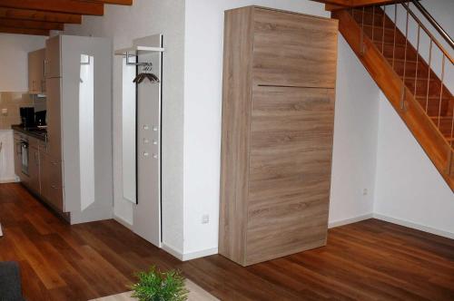 a large wooden door in a room with a staircase at Haus-Auetal in Bliedersdorf