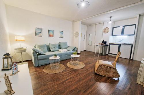 a living room with a blue couch and two tables at #L8 Le Montorge City center Studio Fully equipped in Grenoble