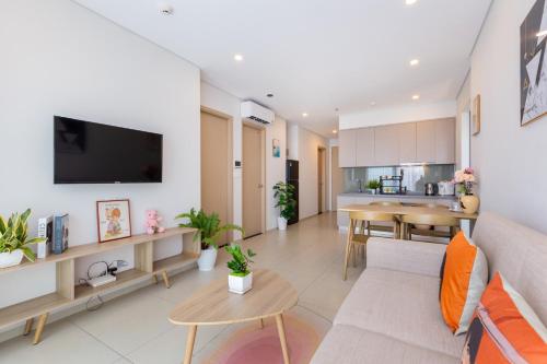 a living room with a couch and a table at The Song Luxury Vung Tau Apartment - QUỲNH's Homestay in Vung Tau