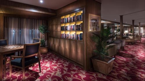 a library with a table and chairs and bookshelves at Steigenberger Royale Nile Cruise - Every Thursday from Luxor for 07 & 04 Nights - Every Monday From Aswan for 03 Nights in Aswan