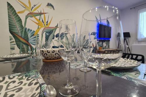 a table with wine glasses and plates on it at Castellane : T2 spacieux - Vue Port - WIFI in Port-Vendres