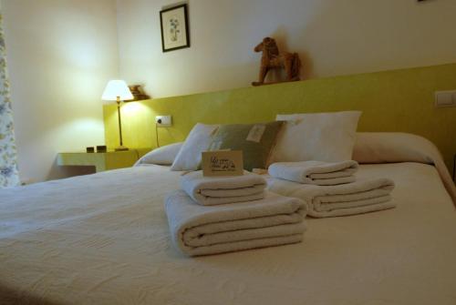 a bedroom with a bed with towels on it at La Casa de Las Titas in Vélez-Málaga