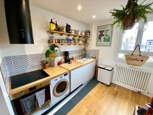 une cuisine avec un évier et une machine à laver dans l'établissement Cosy Cocoon in St-Ouen/Flea Mrkt, à Saint-Ouen