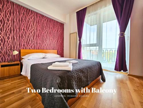 a bedroom with a bed with two towels on it at Rosuites Apartment Accommodation in Bucharest