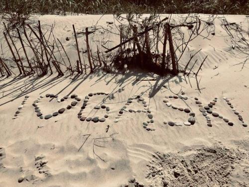 a sign written in the sand in the snow at Wczasowa Gąska in Gąski