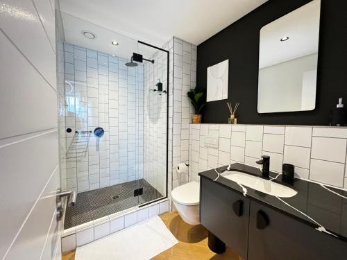 a bathroom with a shower and a toilet and a sink at S.A.E. Nine Palms Luxury in Cape Town