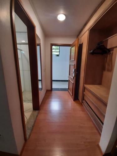a hallway of a house with wooden floors and a door at Paradies Hotel Express in Jarinu