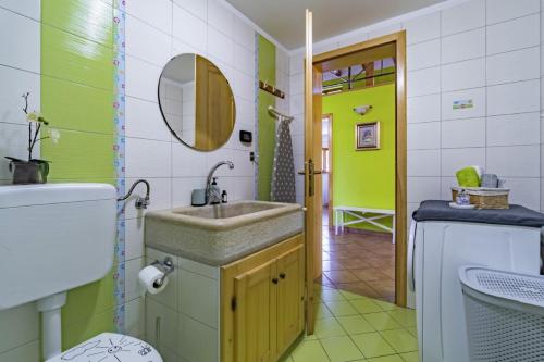 a bathroom with a sink and a washing machine at Bella Collina in Krajcar Brijeg - Haus für 4-5 Personen in Žminj
