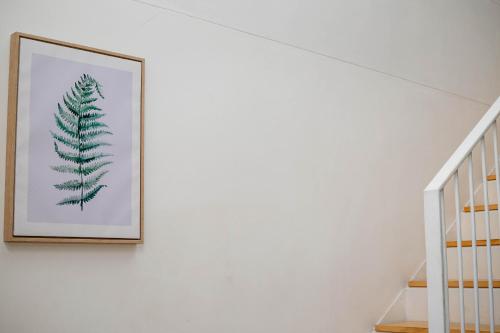 a picture of a fern on a wall next to a staircase at Urban Oasis Apartments at Freedom Plaza in Windhoek