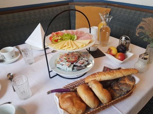 a table with a plate of food on it at Gasthof Brandlhof in Wolfsegg am Hausruck