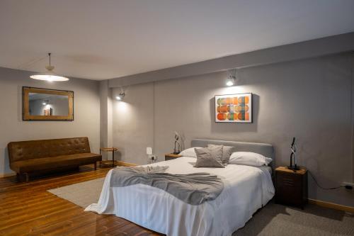 a bedroom with a bed and a couch at Lungarno Buozzi 7 Apartments in Pisa