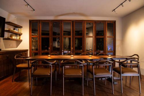 a dining room with a large wooden table and chairs at Tierra Magnifica Boutique Hotel in Nosara