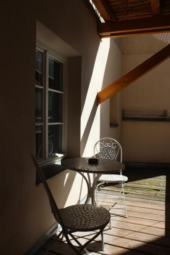 two chairs and a table on a porch at City Center Golden Roof 5 in Innsbruck