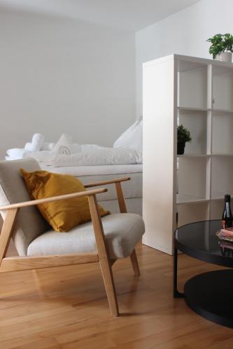 a living room with a chair and a bed at City Center Golden Roof 5 in Innsbruck