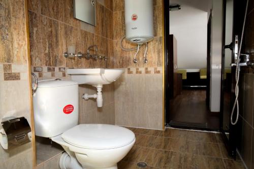 a bathroom with a toilet and a sink at Бялата къща in Zlatograd