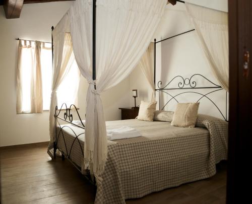 Ένα ή περισσότερα κρεβάτια σε δωμάτιο στο Agriturismo Podere Acqualoreto