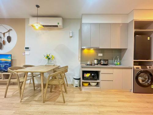 a kitchen and dining room with a table and chairs at The Song Luxury Vung Tau Apartment - QUỲNH's Homestay in Vung Tau