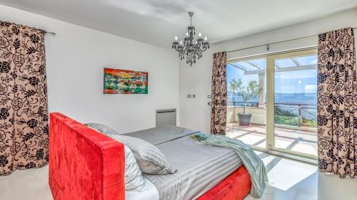 1 dormitorio con cama y ventana grande en Villa Over The Hilltop, en Bencani