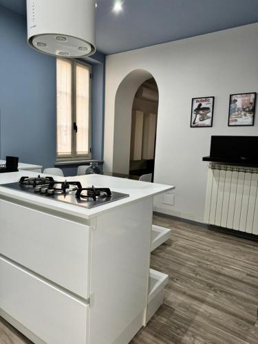 a kitchen with a stove top island in a room at Le Tre Ca', Ca' Cecilia, Ca' Nina, Ca' Vittoria in Asti
