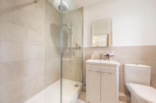 a bathroom with a shower and a toilet and a sink at Deerwood in Grimston