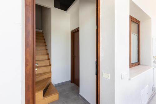 a staircase in a house with white walls at Al civico 5 - Mondern Apartments & Suite! in Decimomannu