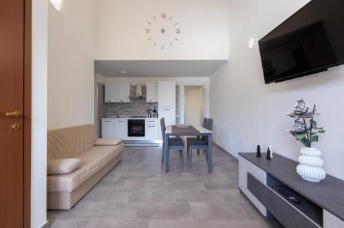 a living room with a couch and a table at Al civico 5 - Mondern Apartments & Suite! in Decimomannu