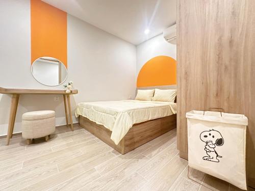 a small bedroom with a bed and a mirror at The Song Luxury Vung Tau Apartment - QUỲNH's Homestay in Vung Tau