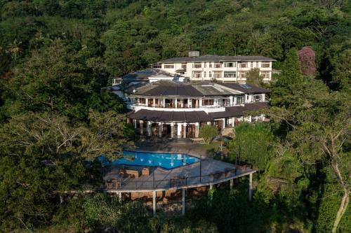 an aerial view of a mansion with a swimming pool at Indra Manel Family Holiday Resort Kandy in Kandy