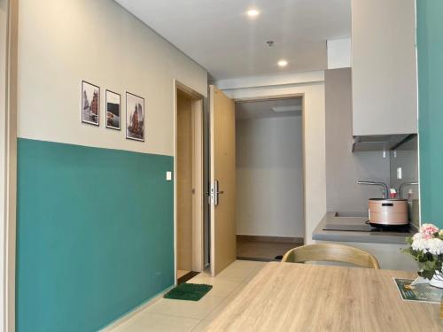 a dining room with a table and a kitchen at The Song Luxury Vung Tau Apartment - QUỲNH's Homestay in Vung Tau
