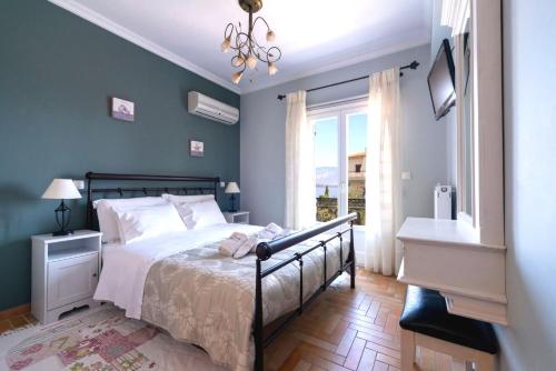 a bedroom with a bed and a chandelier at Nautilus Luxury Suites in Galaxidi