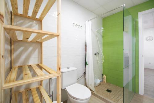 a bathroom with a toilet and a glass shower at Casa la Viña in Chiclana de la Frontera