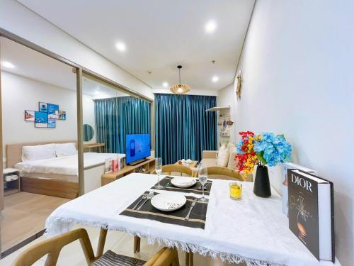 a room with a table and a bed and a room at The Song Luxury Vung Tau Apartment - QUỲNH's Homestay in Vung Tau