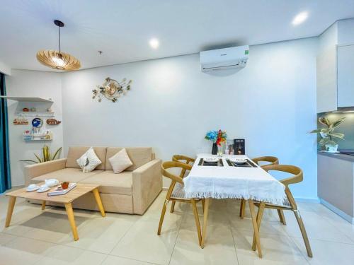 a living room with a table and a couch at The Song Luxury Vung Tau Apartment - QUỲNH's Homestay in Vung Tau