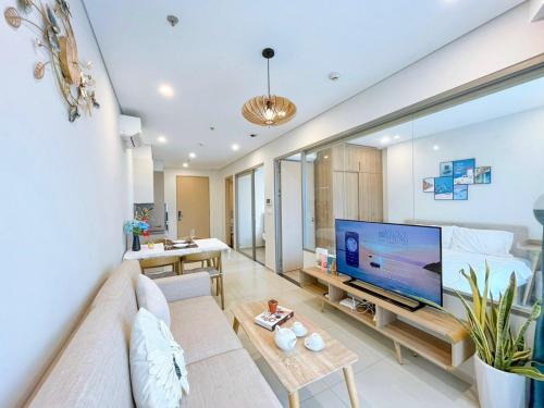 a living room with a large flat screen tv at The Song Luxury Vung Tau Apartment - QUỲNH's Homestay in Vung Tau
