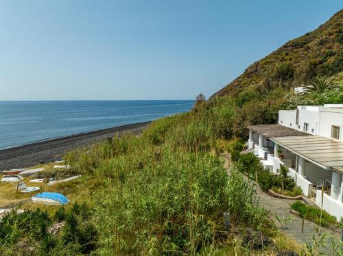 a view of the beach from the side of a building at Villa Ginestra sulla spiaggia di Stromboli in Stromboli
