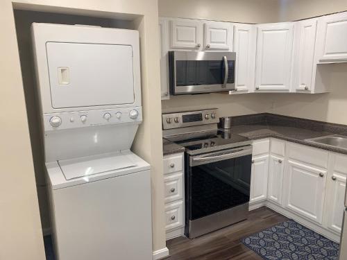 a kitchen with white cabinets and a microwave at Brand new bedroom next Camden yard , convention center in Baltimore