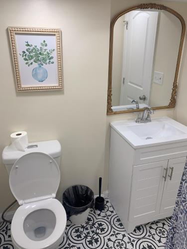 a bathroom with a toilet and a sink and a mirror at Brand new bedroom next Camden yard , convention center in Baltimore