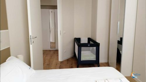a small room with a bed and a mirror at Baia di Luna in Santa Marinella