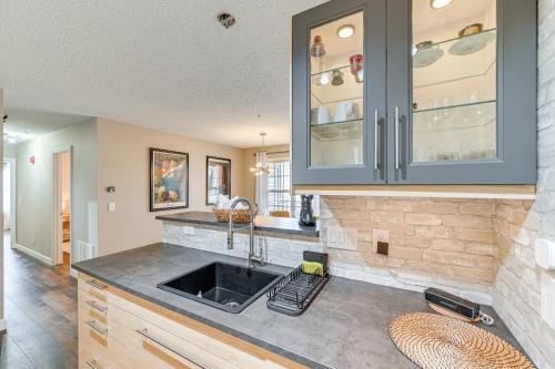 a kitchen with a sink and a counter at Winston-Salem Condo with Balcony Steps to Golf! in Winston-Salem