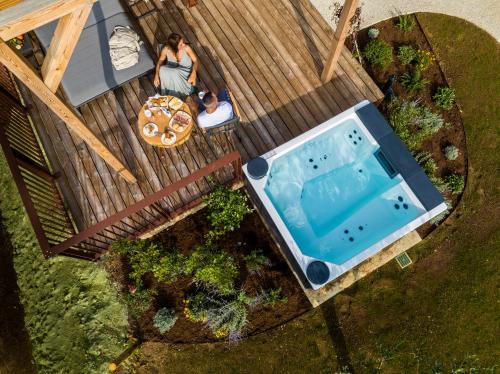 an overhead view of a woman standing on a deck next to a pool at Glamping Alvearium Alturis in Gagliano